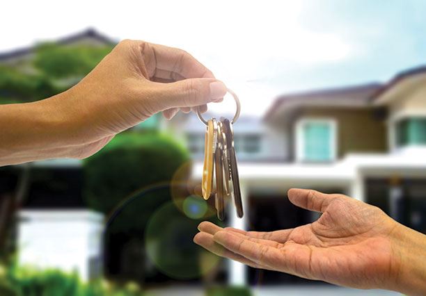 Image of someone handing off the keys to a new home