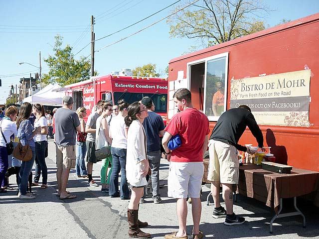 Food Truck Hub with multiple vendors and people in standing in line to buy