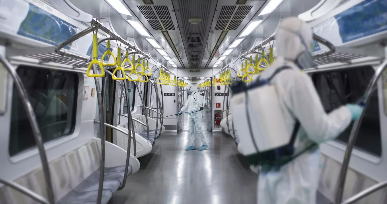 A group of masked men sterilizing the metro, after a public health emergency.