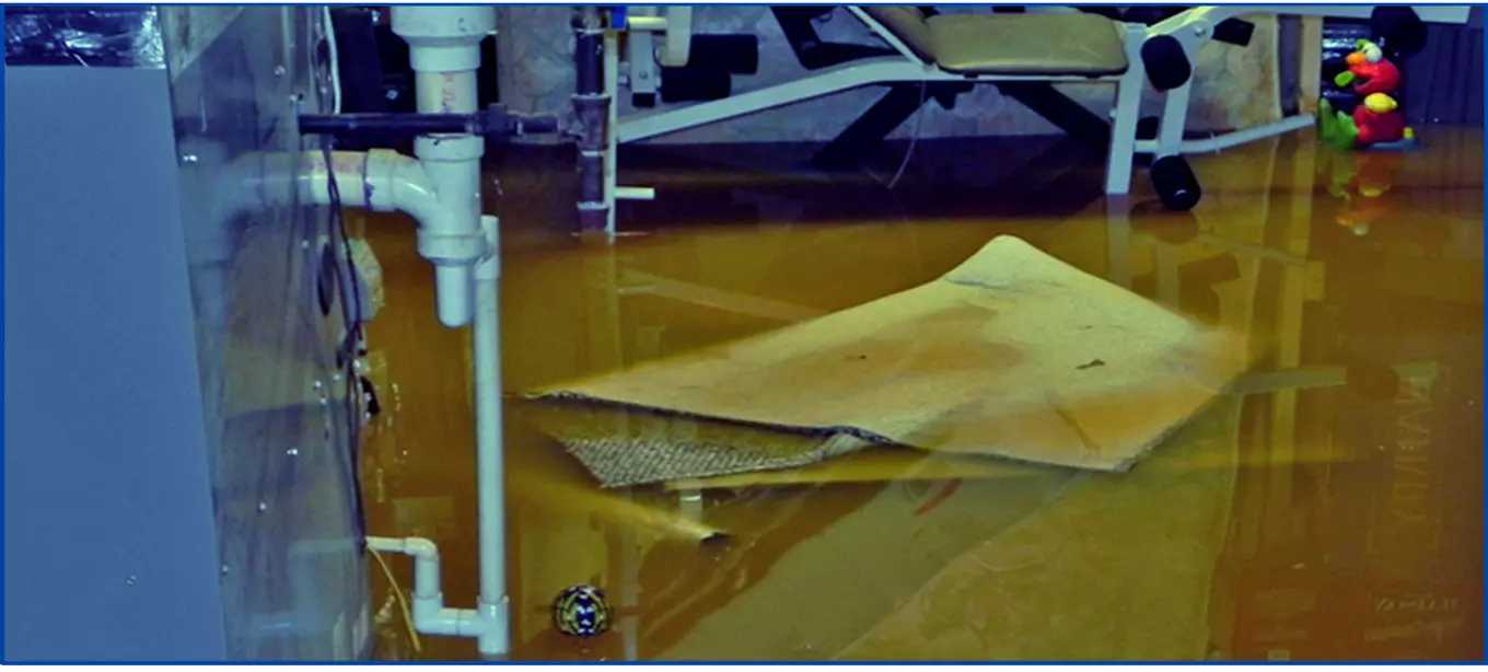 Photo of flooded basement with items floating in water.