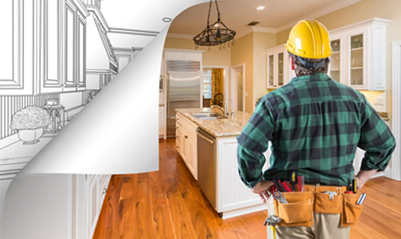 Homeowner Construction, homeowner standing in kitchen visualizing blueprint into finished room