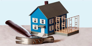 Large hammer, small blue house, framing for addition, indicating unpermitted construction