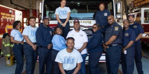 group picture in front of a fire truck