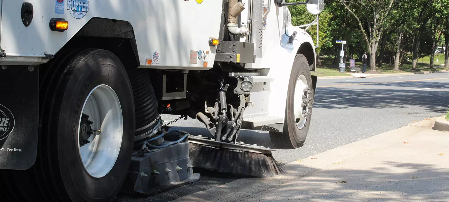 side of street sweeper in action